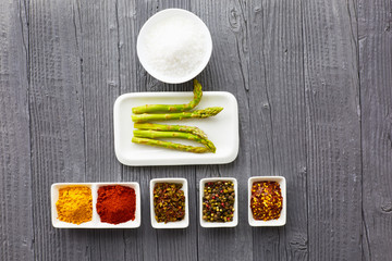Fragrant spices in a white plate on wooden background