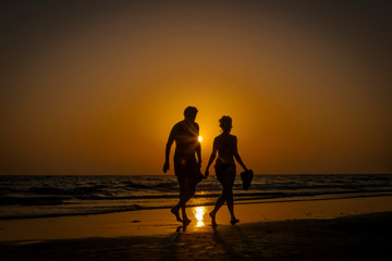 Silhouettes on the shore of the sea, Cadiz, Spain.