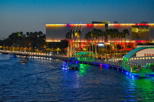 Tampa Bay, Florida. March 02, 2019 Illuminated Tampa Museum of Art, Riverwalk and boats sailing on Hillsborough river in downtown area.