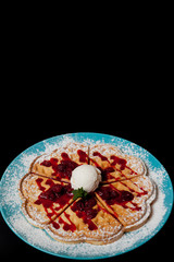 Chopped caramelized apples for breakfast on a black background