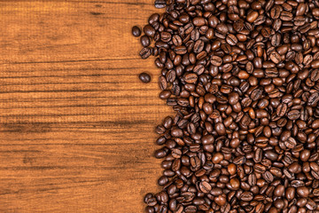 A coffee beans and wood background.
