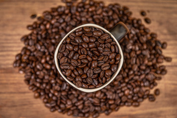A mug and coffee beans composition.