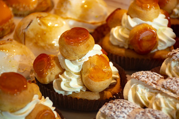 Freshly baked stuffed sweet Saint-Honore pastries in traditinal French bakery in small village in Provence