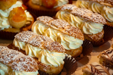 Freshly baked stuffed sweet Paris-Brest pastries in traditinal French bakery in small village in Provence