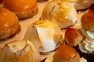 Freshly baked stuffed sweet pastries Orange Lactee and Dome Citron with fruits in traditinal French bakery in small village in Provence