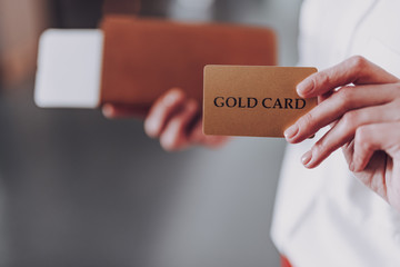 Woman is holding payment card and boarding documents