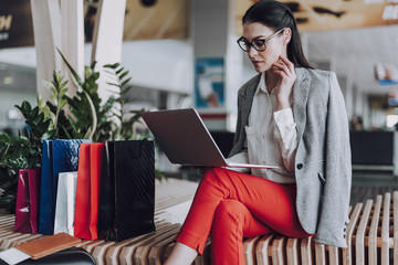 Concentrated woman is working on notebook before flight