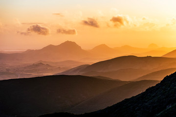 Obraz premium Layers of Mountains at Orange Sunset