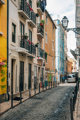 Colorful narrow cobblestone street in Bairro Alto, Lisbon, Portugal