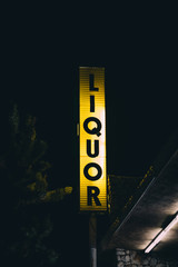 Liquor store sign at night, in Yucca Valley, California