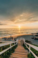Fototapeta premium Vibrant sunset over a staircase and the Pacific Ocean at Windansea Beach, in La Jolla, San Diego, California