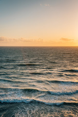 Waves in the Pacific Ocean at sunset, in Encinitas, San Diego County, California