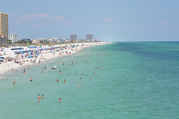 Fototapeta na wymiar Beach goers at Pensacola Beach in Escambia County, Florida on the Gulf of Mexico, USA