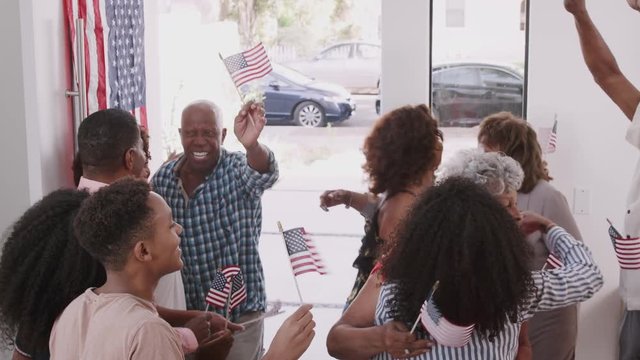 Black family arriving for a house party to celebrate Independence Day with relatives, elevated view