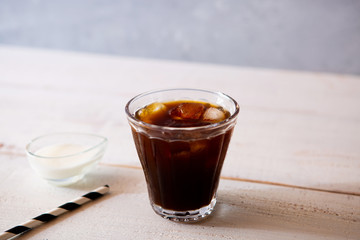glass of iced coffee on white wooden table