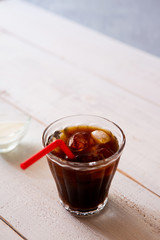 glass of iced coffee on white wooden table