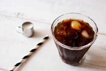 glass of iced coffee on white wooden table