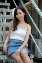 Portrait of thai china adult beautiful girl White shirt blue jeans relax and smile
