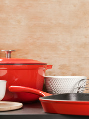Cookware set: Red enameled cast iron pot, saucepan and bowls 