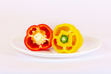 Sliced bell pepper red and yellow lies on the plate.
