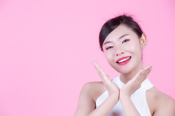 Fashion girl dress up with hand gestures on a pink background.