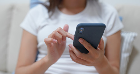 Close up of woman use of mobile phone at home