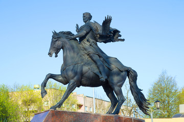 Fototapeta na wymiar A sculpture of Prince Vseslav close-up against a blue sky
