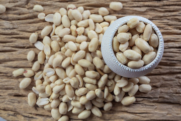 Peanut seeds on a wooden background in the kitchen