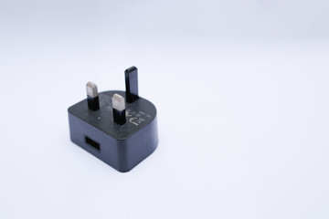 Black USB charger head/adapter isolated on a white background