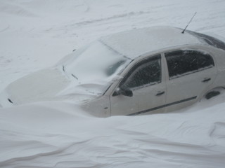 Snow reality of winter in the city. Parked cars near the house. Winter parking. 