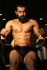 Fototapeta na wymiar Asian Indian beard strong man bodybuilder athletic fitness man pumping up abs muscles workout bodybuilding concept - Image