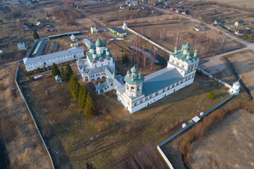 A view from the heights of the churches of the Nikolo-Vyazhishsky monastery on an April afternoon (aerial photography). Vyazhishchi, Novgorod region. Russia