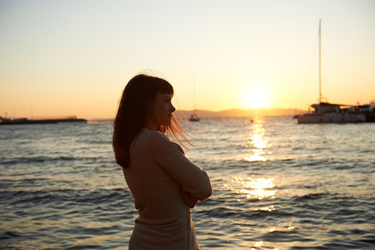 portrait of a beautiful woman in the evening, a beautiful sunset on the sea