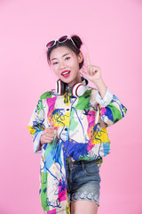 Fashion girl dress up with hand gestures on a pink background.