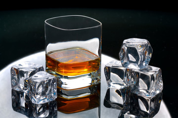 glass of whiskey and ice on table