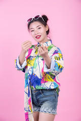 Fashion girl dress up with hand gestures on a pink background.