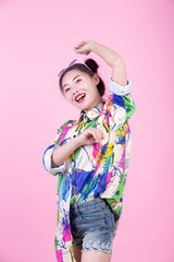 Fashion girl dress up with hand gestures on a pink background.
