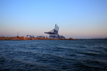 Fototapeta na wymiar Cranes at the cargo terminal in the evening