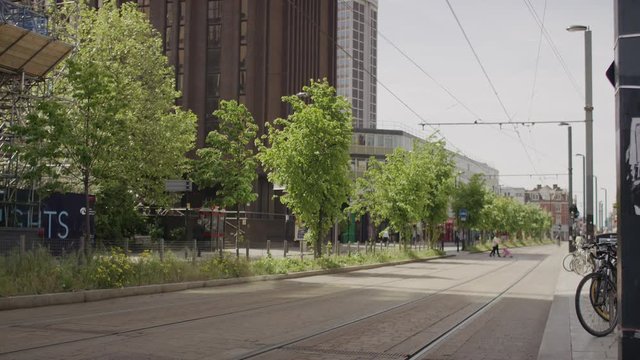 Empty street exterior with pedestrians in the distance