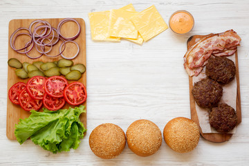 Cheeseburger ingredients, overhead view. From above, top view, flat lay. Copy space.
