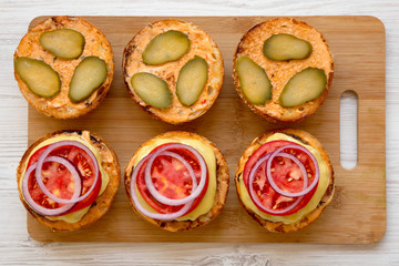 Cooking cheeseburger step-by-step, top view. Flat lay, from above, overhead. Close-up.