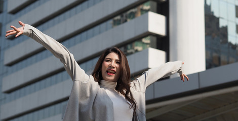 Beautiful asian business woman happy and cheerful or successful feeling with job which action like...
