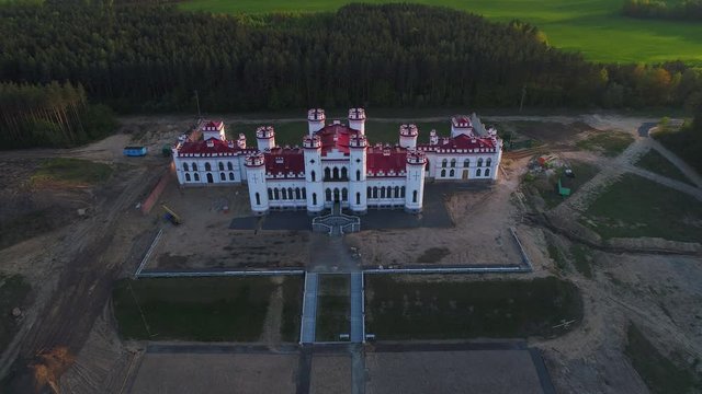 View on the old castle-palace Puslovsky, April day. Kossovo, Belarus (aerial video) 