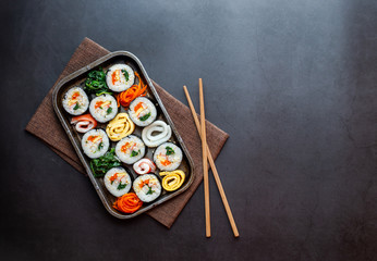 Set of kimbub or sushi roll in steel plate ready to serve in korean style menu with chopstick.