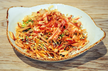 Okonomiyaki. Japanese savory pancake, with noodles, cabbage, seafood. Dish from Japan. Famous street food.
