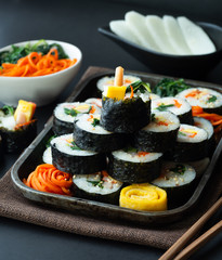 Set of kimbub or sushi roll in steel plate ready to serve in korean style menu with chopstick.