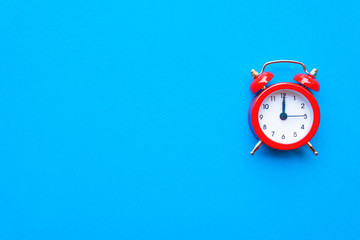 Abstract creative flat lay vintage blue table top view office background concept red clock on paper color in minimal style, Hot summer holiday time to break workplace at noon for lunch, Retro