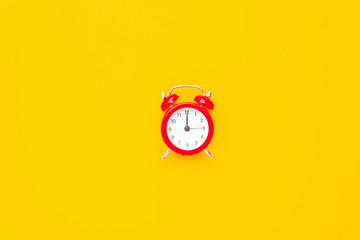Abstract creative flat lay vintage yellow table top view office background concept red clock on paper color in minimal style, Hot summer holiday time to break workplace at noon for lunch, Retro