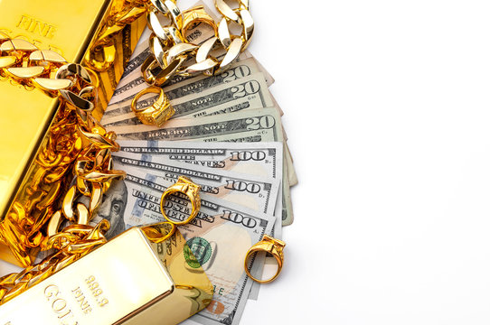 Jewelry buyer, pawn shop and buy and sell precious metals concept theme  with a pile of cash in US dollars, golden rings, necklace bracelet and gold  bullion isolated on white background with