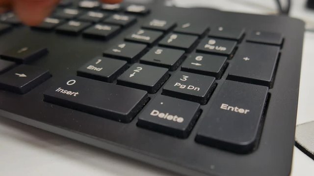 Hand close up of a man to typing keyboard for calculate numeric